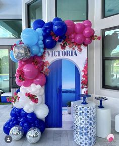 the entrance to victoria is decorated with blue, pink and white balloons in front of it