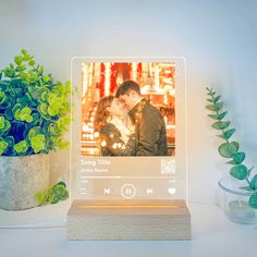 an image of a couple kissing in front of a photo frame with headphones on