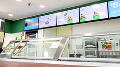 a fast food restaurant with menus on the wall