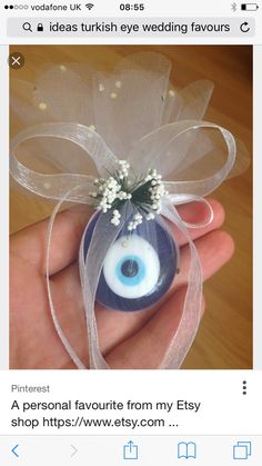 an evil eye ornament with baby's breath attached to the front of it