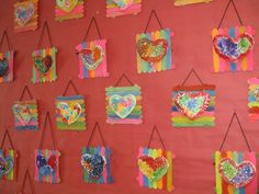 the wall is decorated with many colorful hearts and ribbons on it's sides, hanging from hooks