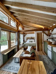 the interior of a tiny cabin with wood flooring