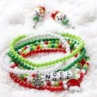 three bracelets with beads and charms on top of snow covered ground next to each other