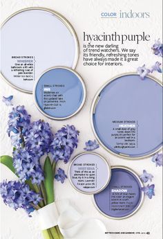 a magazine page with purple paint and flowers in the center, including bluebells