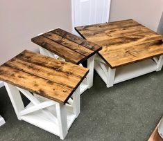 two tables made out of pallet wood sitting on top of carpeted flooring