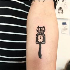 a cat with a clock tattoo on its arm