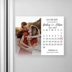 a save the date magnet with an image of a couple kissing in front of a refrigerator