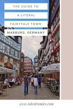 people walking down a cobblestone street in germany with text overlay that reads the guide to a literally fairytale town marburg germany