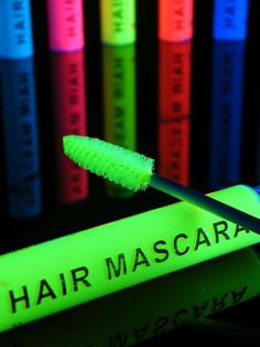 a green toothbrush sitting in front of neon colored books