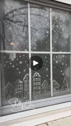 the window is decorated with chalk drawings on it