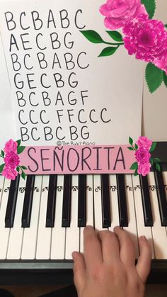 someone is playing the piano with pink flowers on it's cover and sheet music