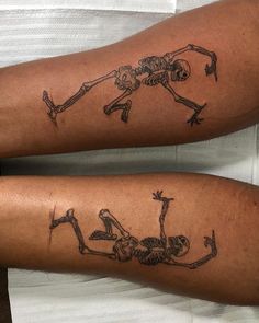 two people with skeleton tattoos on their legs