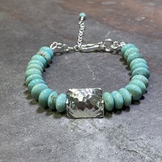 "Beautiful Turquoise doesn't need much else and this bracelet proves it.  A single handmade fine silver rectangle in the center shows off the stunning blue-green of these Kingman Turquoise.  A hook and chain allows for flexibility in length from 6\" - 7.5\".    Bracelet shown is representative of actual bracelets in stock, from the same batch of turquoise.   Thanks so much for stopping by, and for supporting small, artisan, and handcrafted goods businesses." Artisan Turquoise Rectangular Jewelry, Handmade Rectangular Turquoise Bracelets, Artisan Turquoise Nickel-free Bracelets, Artisan Nickel-free Turquoise Bracelets, Rectangular Turquoise Jewelry With Natural Stones, Rectangular Turquoise Natural Stone Jewelry, Hill Tribe Silver, Kingman Turquoise, Belfast