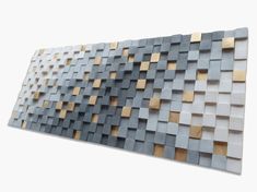 a large metal wall sculpture with wooden squares on it