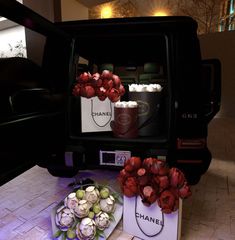 a bunch of flowers sitting on top of a table next to a bag and remote control