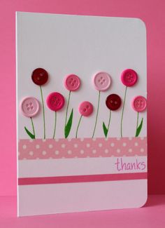 a pink and white card with buttons on it