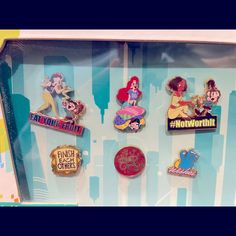 there are many pin badges on display in the case, including one for each disney character