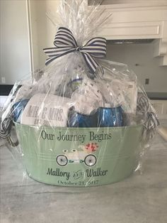 a basket filled with blue and white baby's items on top of a counter