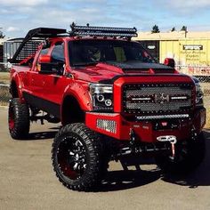 a large red truck parked on top of a parking lot