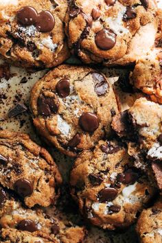 chocolate chip cookies with marshmallows and chocolate chips are piled on top of each other