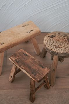 three wooden stools sitting on top of a hard wood floor