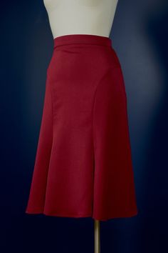 "The Florence-skirt is adapted from a 1930s sewing pattern. The skirt features curved seam lines that accentuate the hips, it fits snugly around the hips and flares out generously toward the knees. The flare at the bottom is close to a full circle! There is a zipper and a hook&bar closure on the side. This skirt is great for any modern vintage look, but it's especially made with dancers in mind, and looks great when you twirl. The skirt is made in a dark burgundy red suiting fabric. The fabric h Classic Fitted A-line Bottoms, Classic Fitted Bottoms With Flared Hem, Classic Fitted Flared Skirt, Elegant Red Gathered Skirt, Fitted Burgundy Pleated Skirt, Elegant Flared Relaxed Skirt, Elegant Burgundy Lined Skirt Bottoms, Fitted Flare Skirt In Solid Color, Solid Fitted Flare Skirt