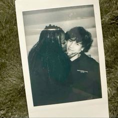 an old black and white photo of two people with long braids on their heads