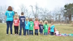 a group of children standing next to each other in a field