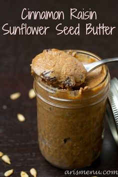 cinnamon raisin sunflower seed butter in a glass jar with a spoon on top