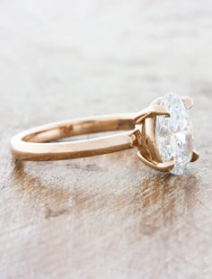 a gold ring with a large diamond on it