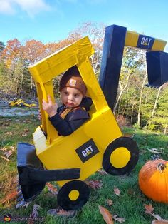 a small child in a construction vehicle costume