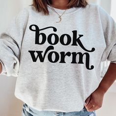 Get your read on<3  Cozy up with your favorite book and our incredibly comfy bookworm sweatshirt MATERIALS: 50% cotton, 50% polyester ABOUT SHOP: AnnessaDesign is a single person run shop that loves to inspire. My goal is to provide happiness, love, kindness, intention etc clothing to serve as daily reminders to be our best self. The designs will also be read by those around you, inspiring them to listen to the message you are wearing. Raise your frequency as well as those around you! Designs are all made by me in Canada and shipped worldwide! I can definitely make any customizations you would like or custom designs, just ask :) Feel free to send a message for any customizations, changes, questions or more. I can't wait to help you! All the best, Christina Annessa Bookworm Style, Teacher Book, Bookworm Shirt, Just One More Chapter, One More Chapter, Librarian Shirt, Teacher Books, Reading Shirts