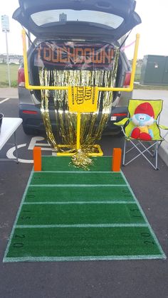 the back end of a bus with an artificial football field