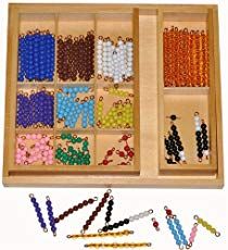 an assortment of beads in a wooden box with matching bead sets on the inside