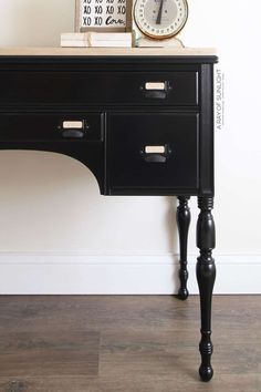 a black desk with a clock on top