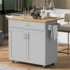 a kitchen island cart with wooden top in a living room