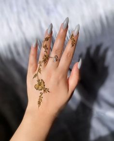 a woman's hand with tattoos on it