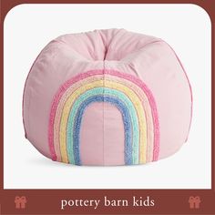 a pink bean bag with a rainbow design