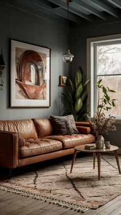 a living room filled with furniture and a large painting on the wall above the couch