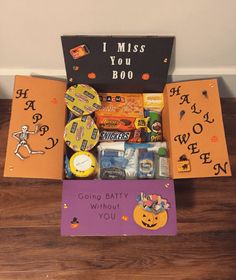 a halloween treat box with candy, candies and treats in it sitting on the floor