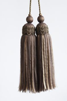 two brown tassels hanging from a rope