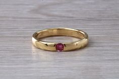 This 18ct yellow gold band is tension set with a natural round cut Ruby18ct yellow gold, 750 grade gold and hall marked in England for your peace of mind and quality assurance.Top grade of Ruby Weighing 0.08ct Width of 3.00mmSuper high polish finishPerfect as wedding band, eternity ring, dress ring, stacker ring, occasion ringIdeal 16th, 18th, 21st birthday gift, Graduation presentFREE SIZING, please inform me of your size requirement even international measurementsGift boxedUK and International Ruby Bands, Tension Setting, Traditional Diamond, Plain Bands, Sparkling Rings, Gift Graduation, Heart Shaped Diamond, Gold Top, Eternity Wedding Band