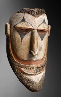 a wooden mask with two faces on it