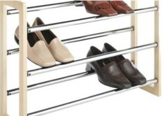 four pairs of shoes are hanging on a rack