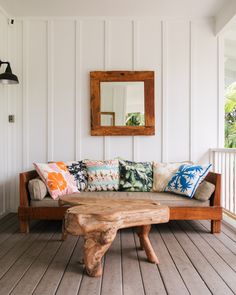 a wooden bench sitting on top of a hard wood floor next to a white wall