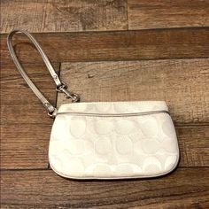 White Coach Wristlet With Silver Leather Lining White Wristlet With Zipper Closure, White Clutch With Wrist Strap For Everyday Use, White Coach Clutch With Zipper Pouch, White Wristlet With Removable Pouch, White Pouch Wristlet With Wrist Strap, White Coach Pouch Wristlet, White Clutch Wristlet With Removable Pouch, White Pouch Wristlet For Daily Use, White Pouch Wristlet With Zipper Closure