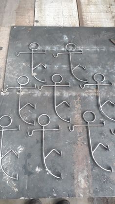 an old metal table with several anchors and arrows drawn on it, along with two pairs of shoes