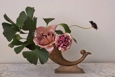 a vase filled with flowers sitting on top of a table