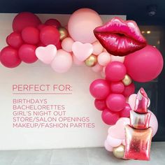 a display with balloons and lipstick on it