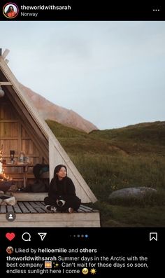 two people sitting in front of a small wooden structure with a fire place on top